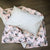 Harlow cot duvet cover with an earl grey pillow sitting on top.