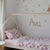 A single bed in a pink room with our Hastings duvet cover and pillow case.