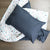 A Sheffied cot duvet cover with a blue Windsor pillow sitting on top. 