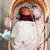 A baby asleep in a moses basket with our Harlow pattern on it. 