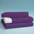 A picture of a purple fitted sheet, flat sheet and pillow case, all folded on top of each other.