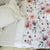 A cot with an Earl Grey fitted sheet and a York Flat sheet on top. 