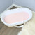 A moses basket in the corner of a room with the Duchess fitted sheet on it. 