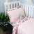 A cot with a complete cot bundle in Hastings and Duchess. 