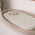 A picture of a moses basket with our Banbury Fitted Sheet on it with a small lamb toy on top. 