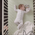 A picture of a baby boy asleep on a Banbury sheet. 